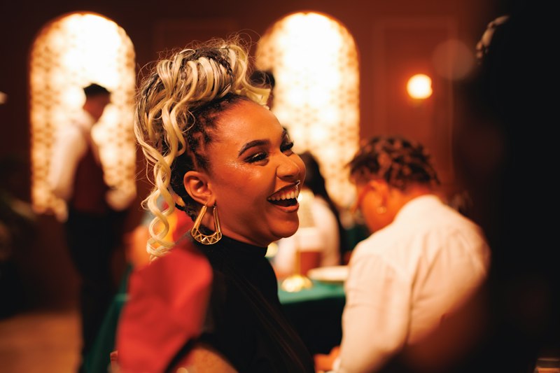 A woman laughing at an evening event